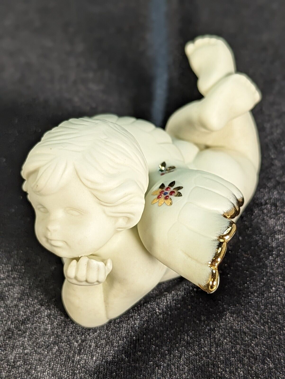 Vintage Cherub Laying Down With Gold Tipped Wings Figurine