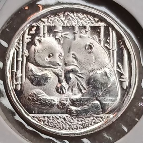 Two Adorable Pandas on a 0.999 Silver 1 Gram Mini Silver Round. CMC Mint