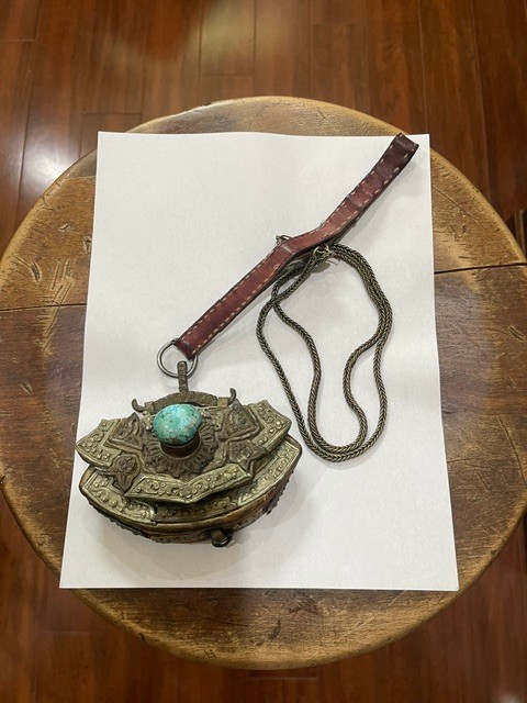 Tibetan Purse Pouch Hanging From A Red Leather Strap With Turquoise Color Stone Tibetan Purse Pouch Hanging From A Red Leather Strap With Turquoise Color Stone
