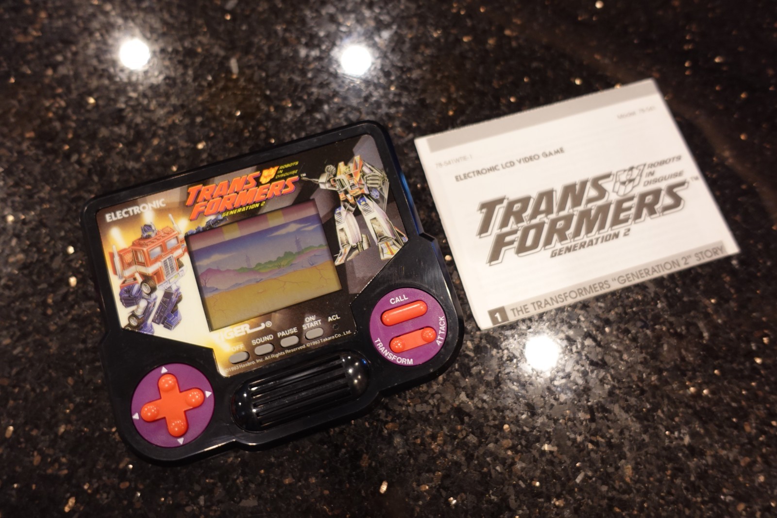 Vintage TRANSFORMERS with BOOKLET by TIGER Handheld Electronic LCD Video game D7