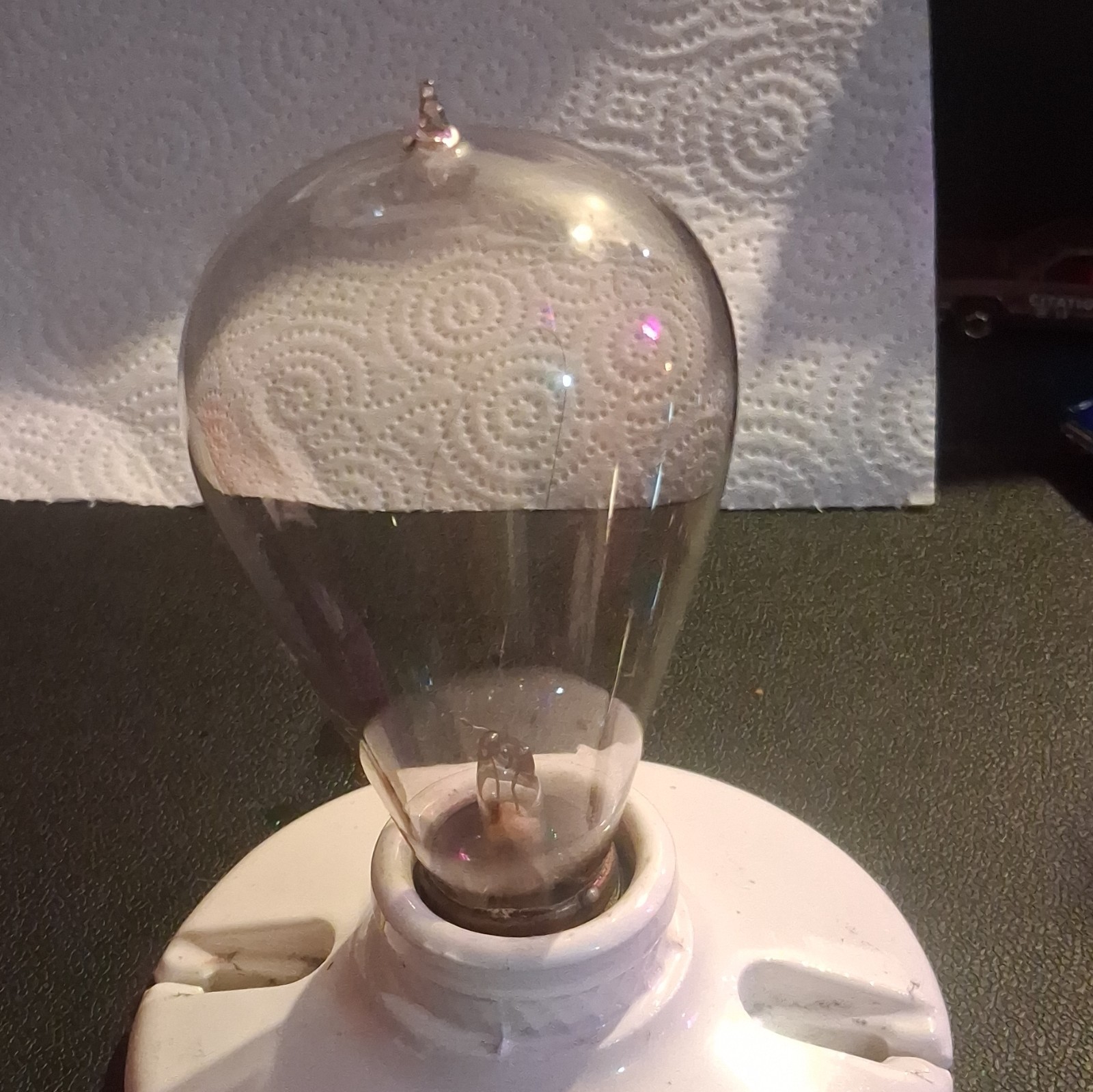 vintage 1890\'s hand blown working light bulb. on a vintage porcelain socket. vintage 1890\'s hand blown working light bulb. on a vintage porcelain socket.