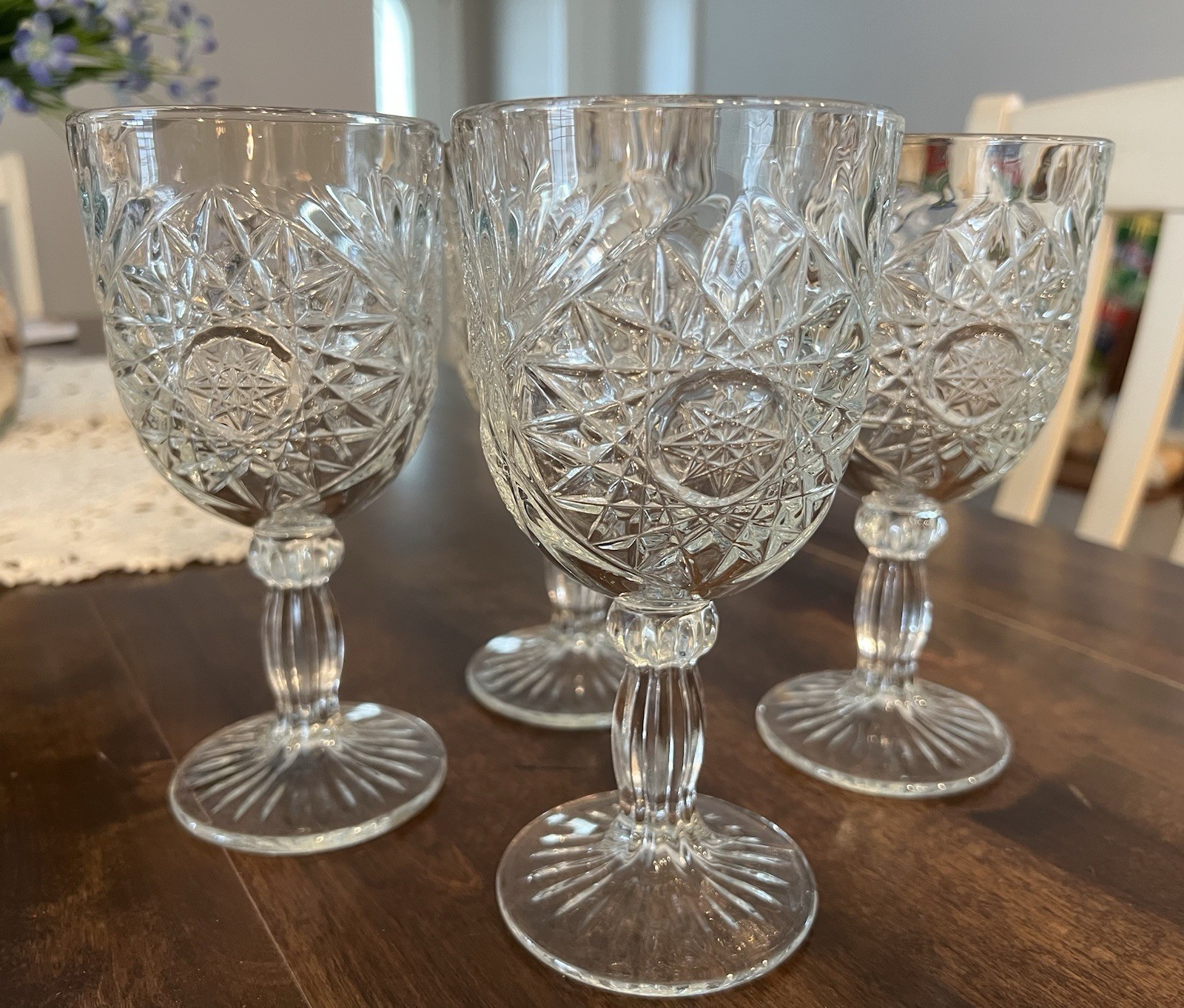 A set of four vintage clear glass hobstar water goblets made by Libbey.