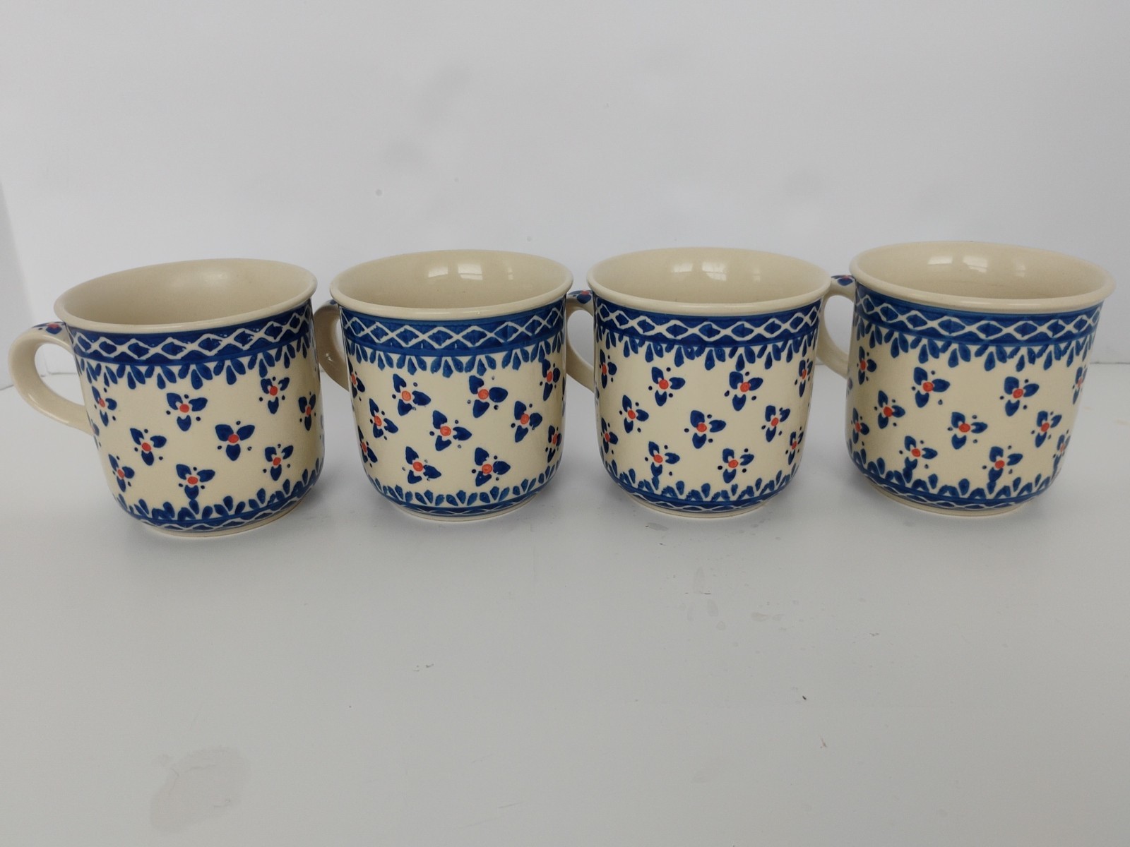 Vintage Poland Wiza Boleslawiec Pottery 4 Coffee Mugs 3 Petal Flower Orange Spot