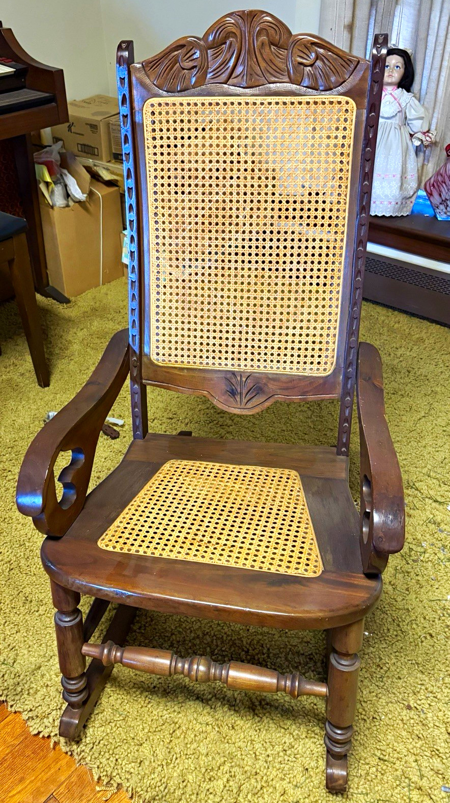 Antique Victorian/Eastlake-style carved walnut rocking chair with cane seat
