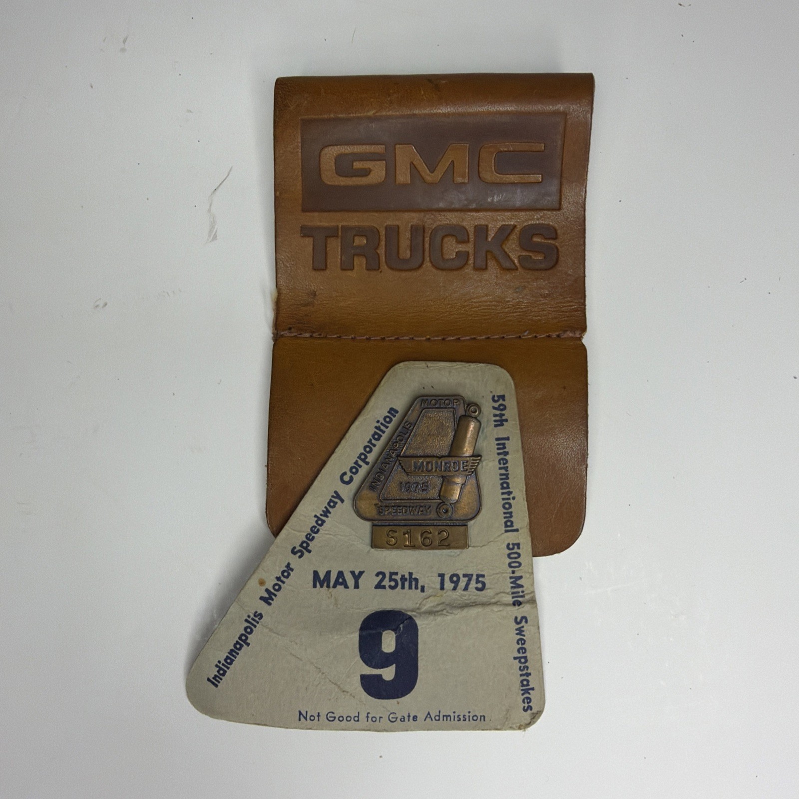 1975 Indianapolis Motor Speedway 500 Pit Badge & GMC Trucks Credential Holder