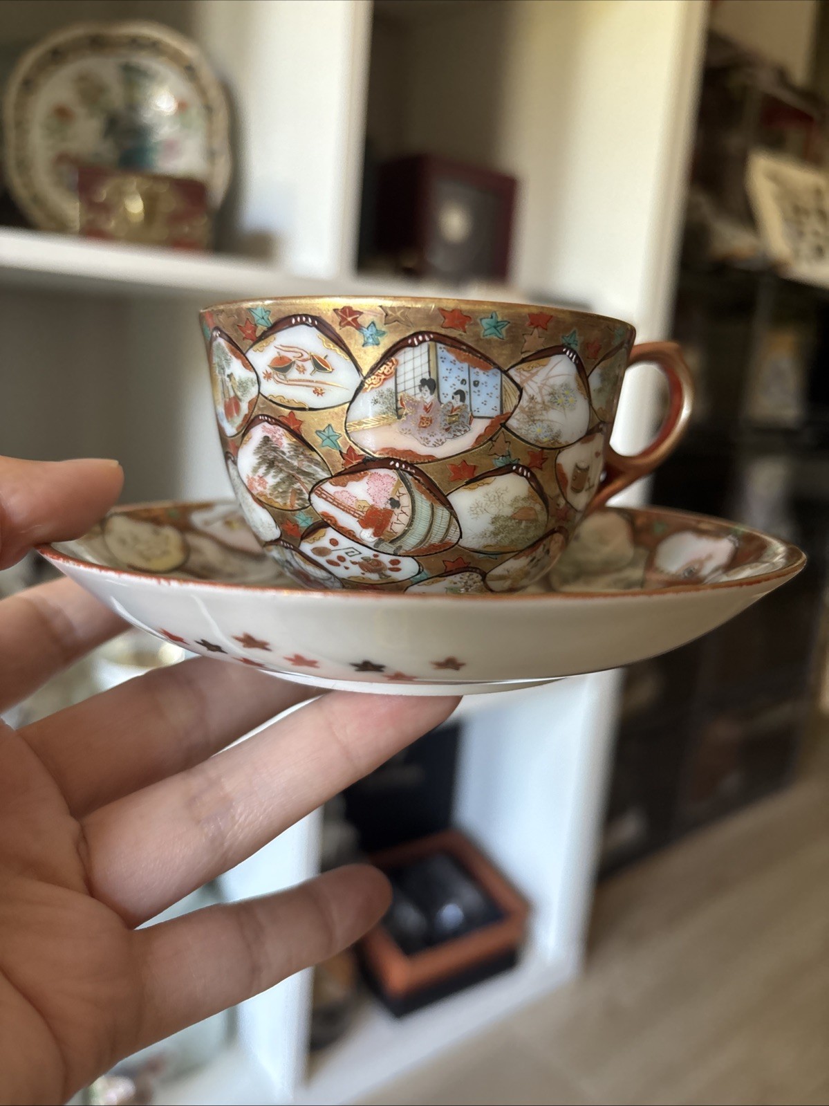 Very detailed antique Japanese porcelain tea cup and saucer set hand-painted
