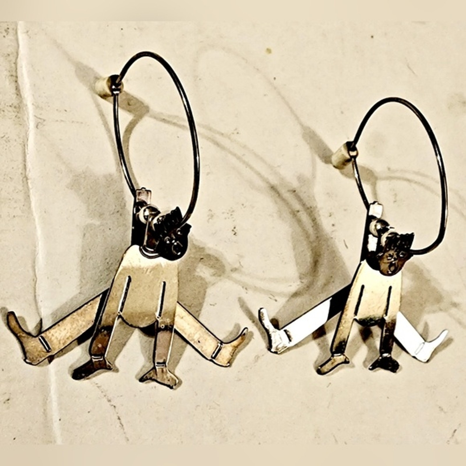 90s 3D layered articulating quirky man  jumping silver tone hoop earrings