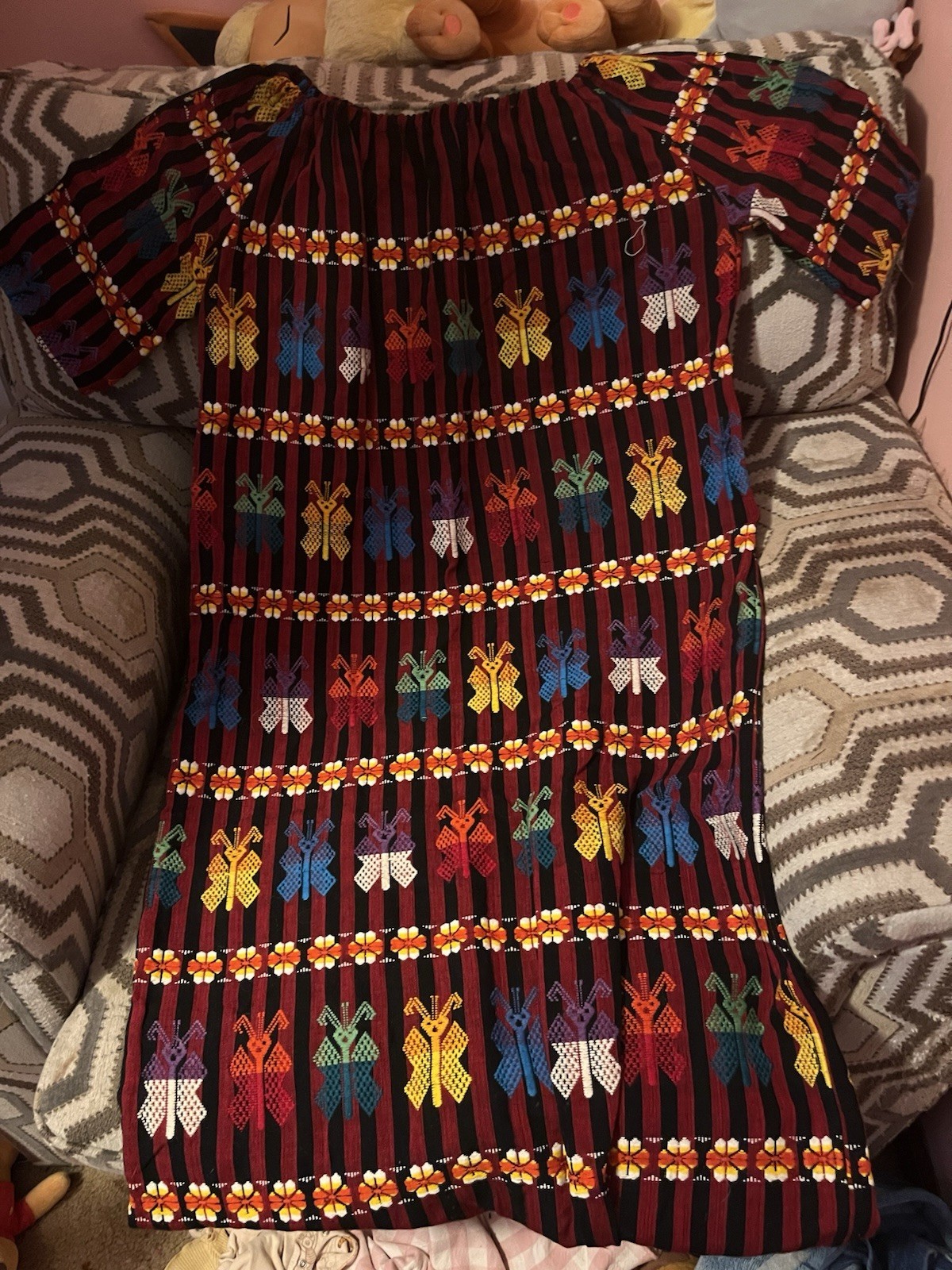 traditional hand-woven and hand-embroidered Guatemalan huipil dress, likely from traditional hand-woven and hand-embroidered Guatemalan huipil dress, likely from