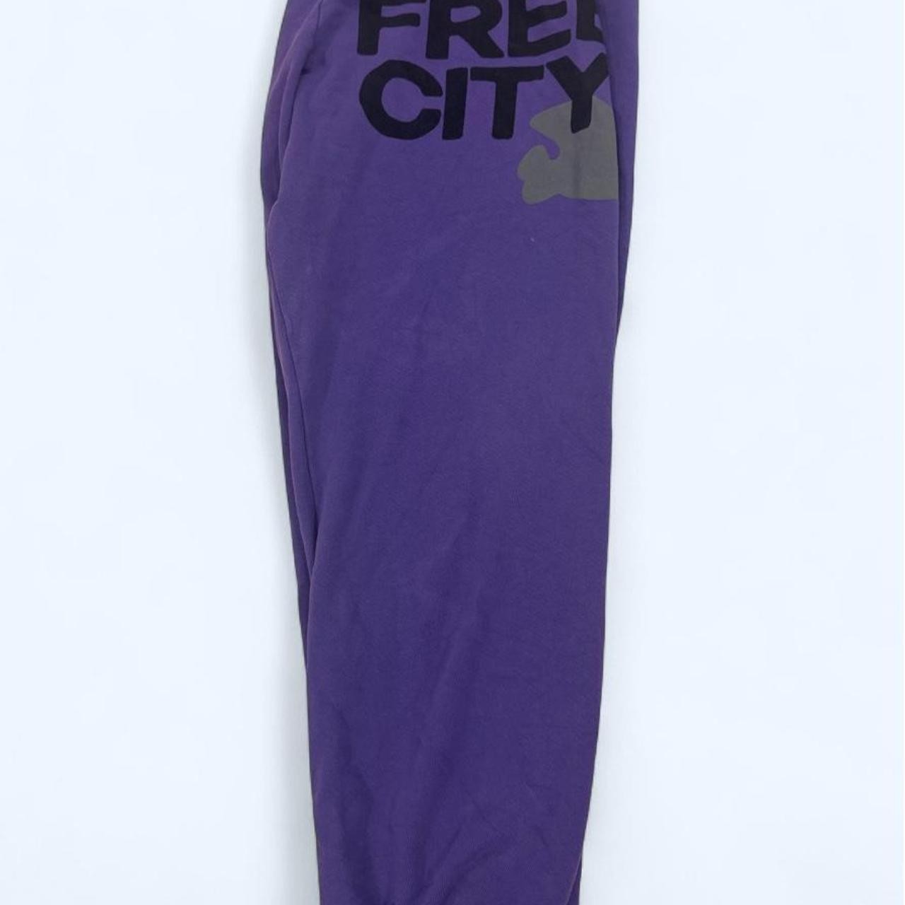 Free City purple sweatpants with black text reading \'FREE CITY\' Free City purple sweatpants with black text reading \'FREE CITY\'