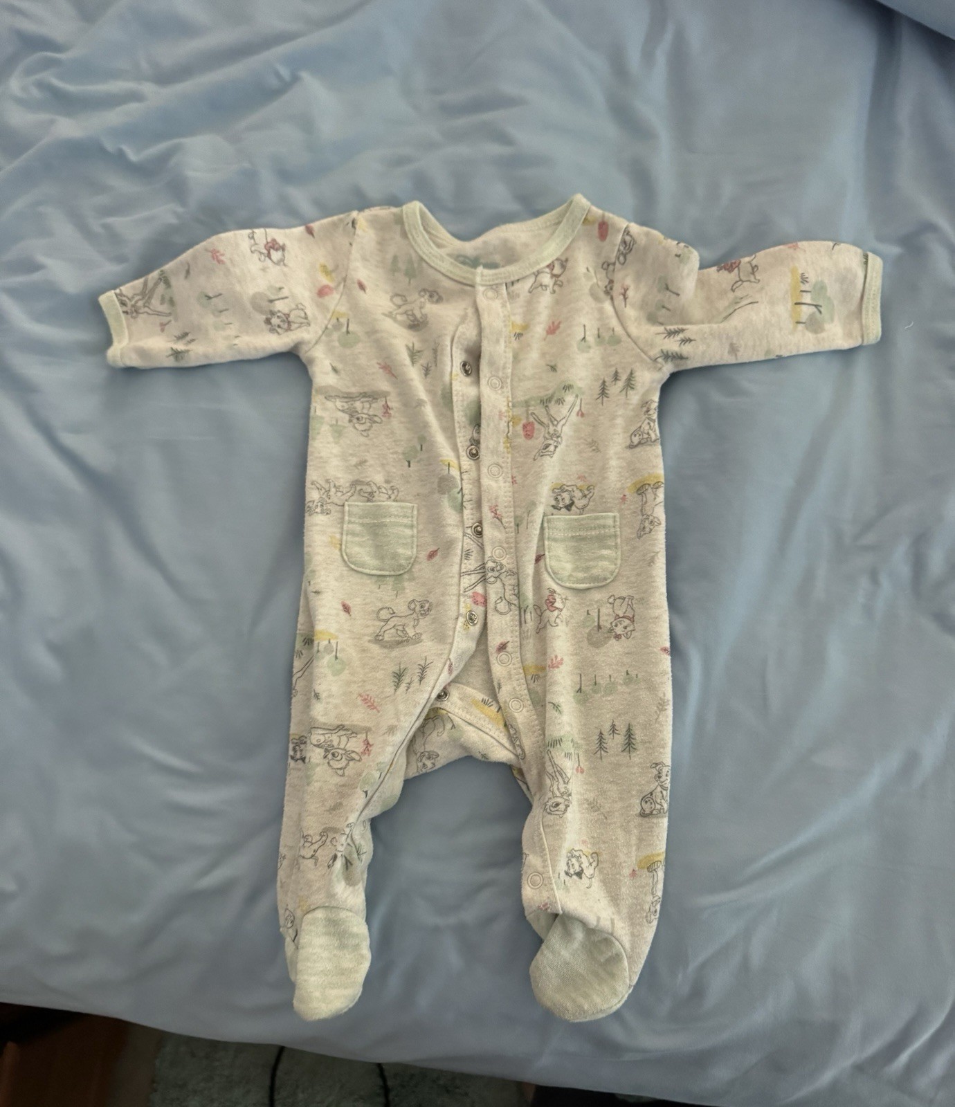 Disney baby footie pajamas with small Disney animal characters, size 0-3m