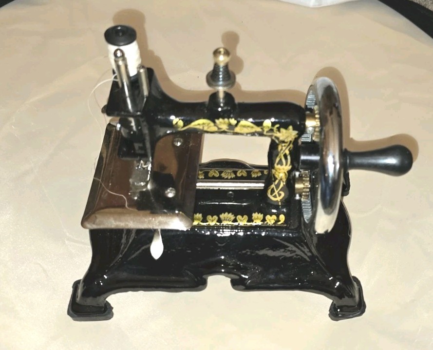 Vintage Child's Toy Sewing Machine. Beautiful Artwork- Working Vintage Child's Toy Sewing Machine. Beautiful Artwork- Working