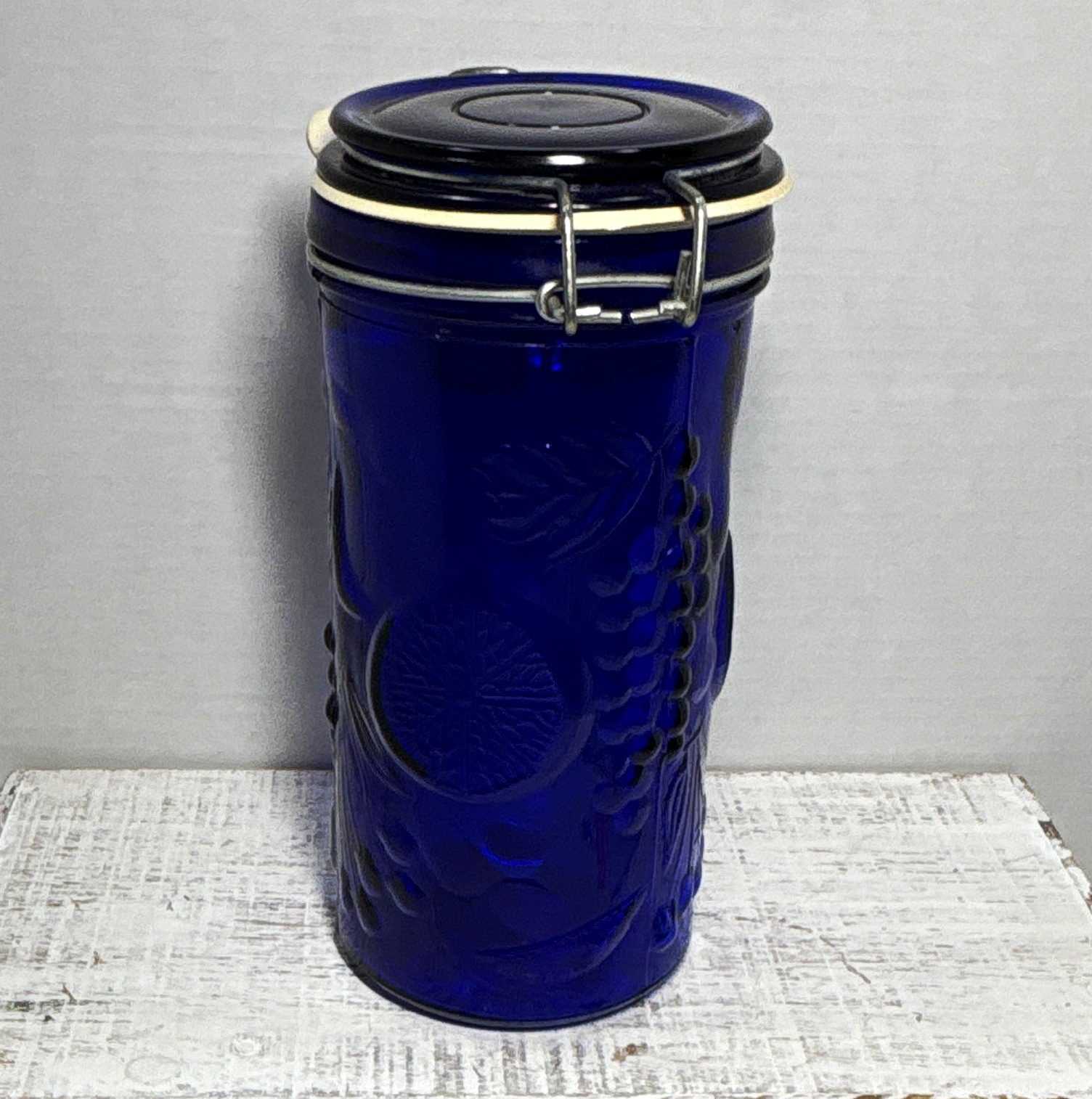 Vintage Cobalt Blue Pressed Glass Canister with Raised Fruit Motif and Bail Lid Vintage Cobalt Blue Pressed Glass Canister with Raised Fruit Motif and Bail Lid