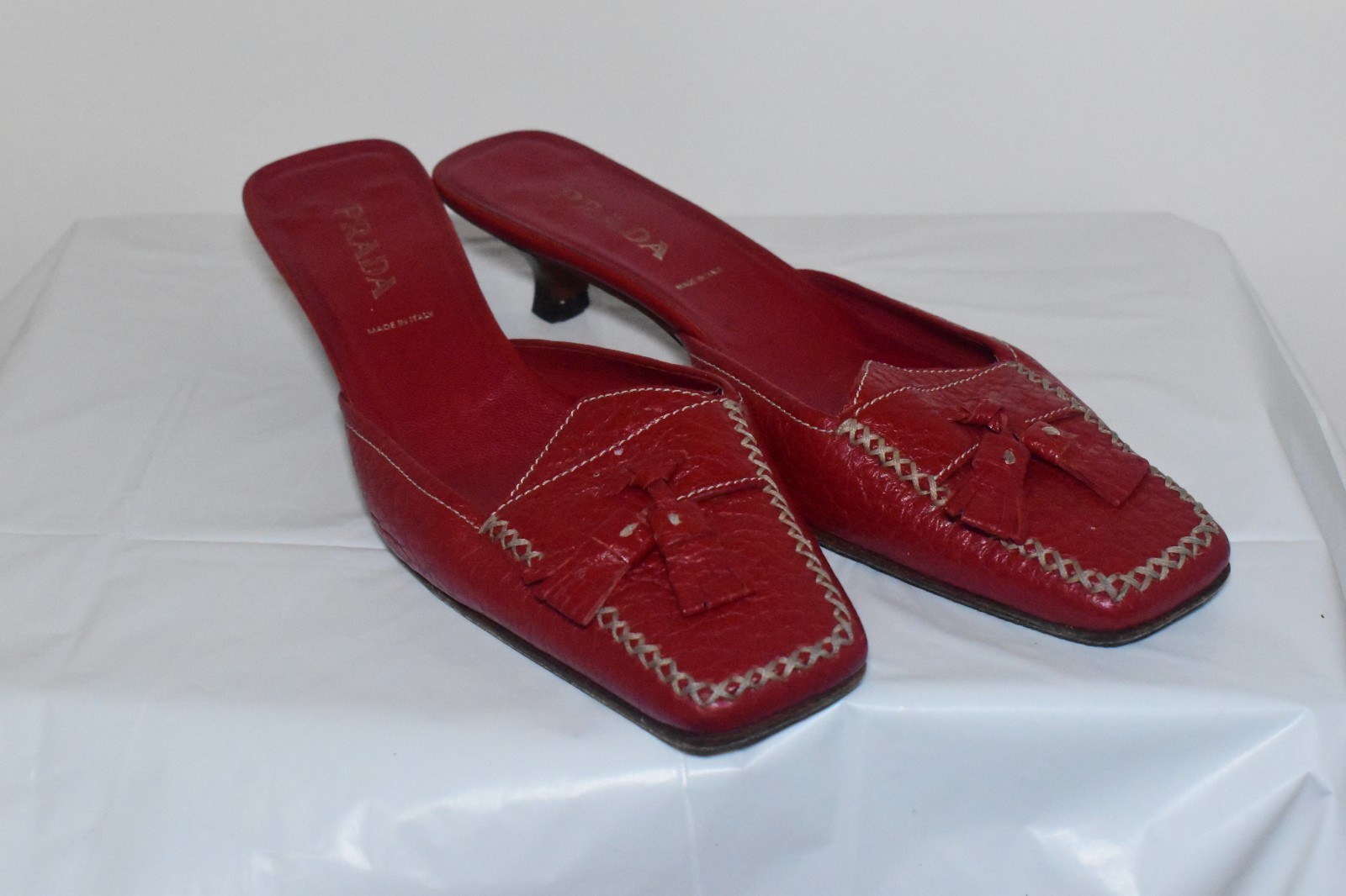 Red Prada Kitten-Heel Mules with Tassel Detail Red Prada Kitten-Heel Mules with Tassel Detail