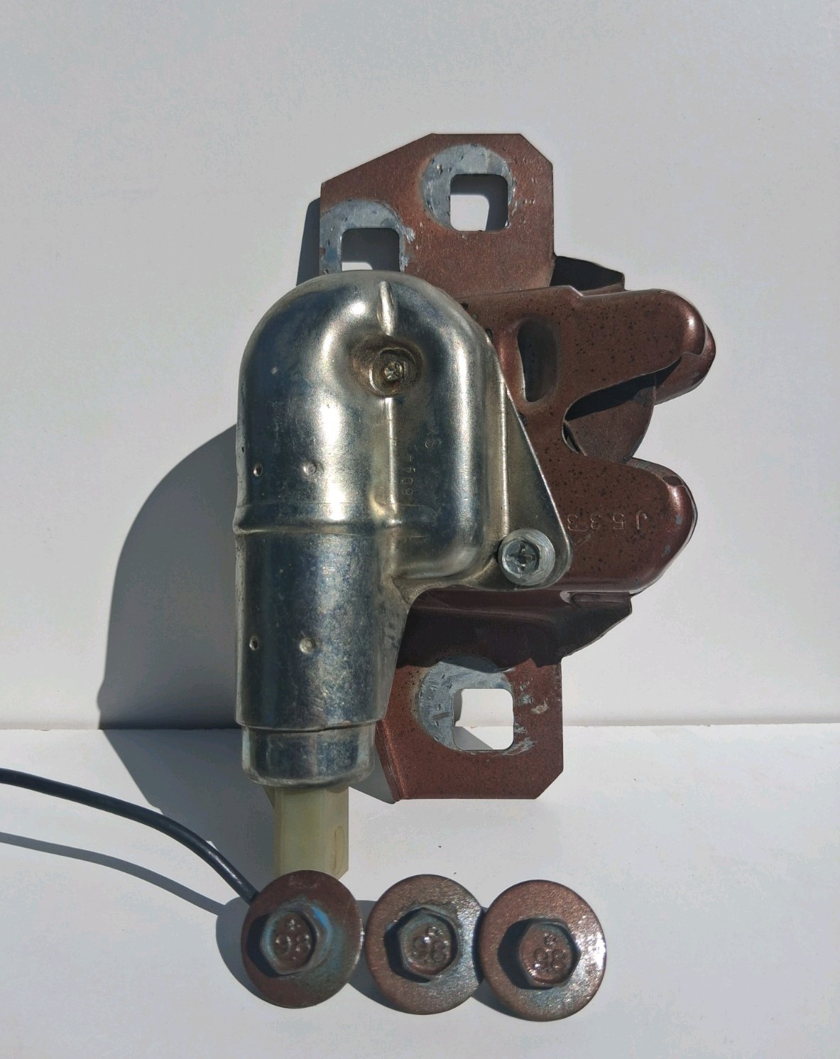 Vintage automotive trunk latch original bolts assembly, likely 1970s-1980s