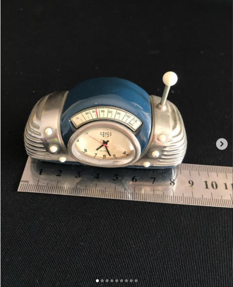 An interesting antique collector\'s clock in the shape of a car speedometer. Made