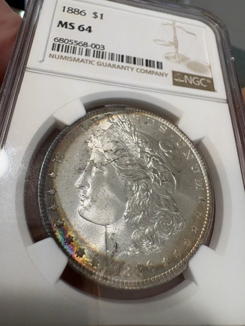 1886 Morgan Silver Dollar Graded NGC MS 64 Small Cats Eye Rainbow Toning $1 Coin 1886 Morgan Silver Dollar Graded NGC MS 64 Small Cats Eye Rainbow Toning $1 Coin