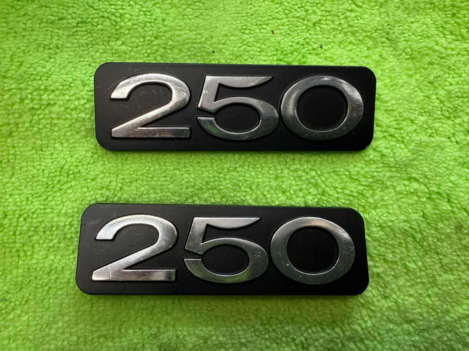 Suzuki  250 OEM NOS sidecover badge