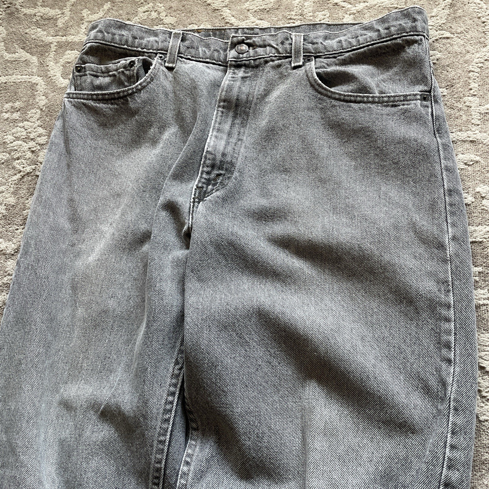 Vintage USA made Levi’s Men’s faded and distressed jeans with a loose fit Vintage USA made Levi’s Men’s faded and distressed jeans with a loose fit