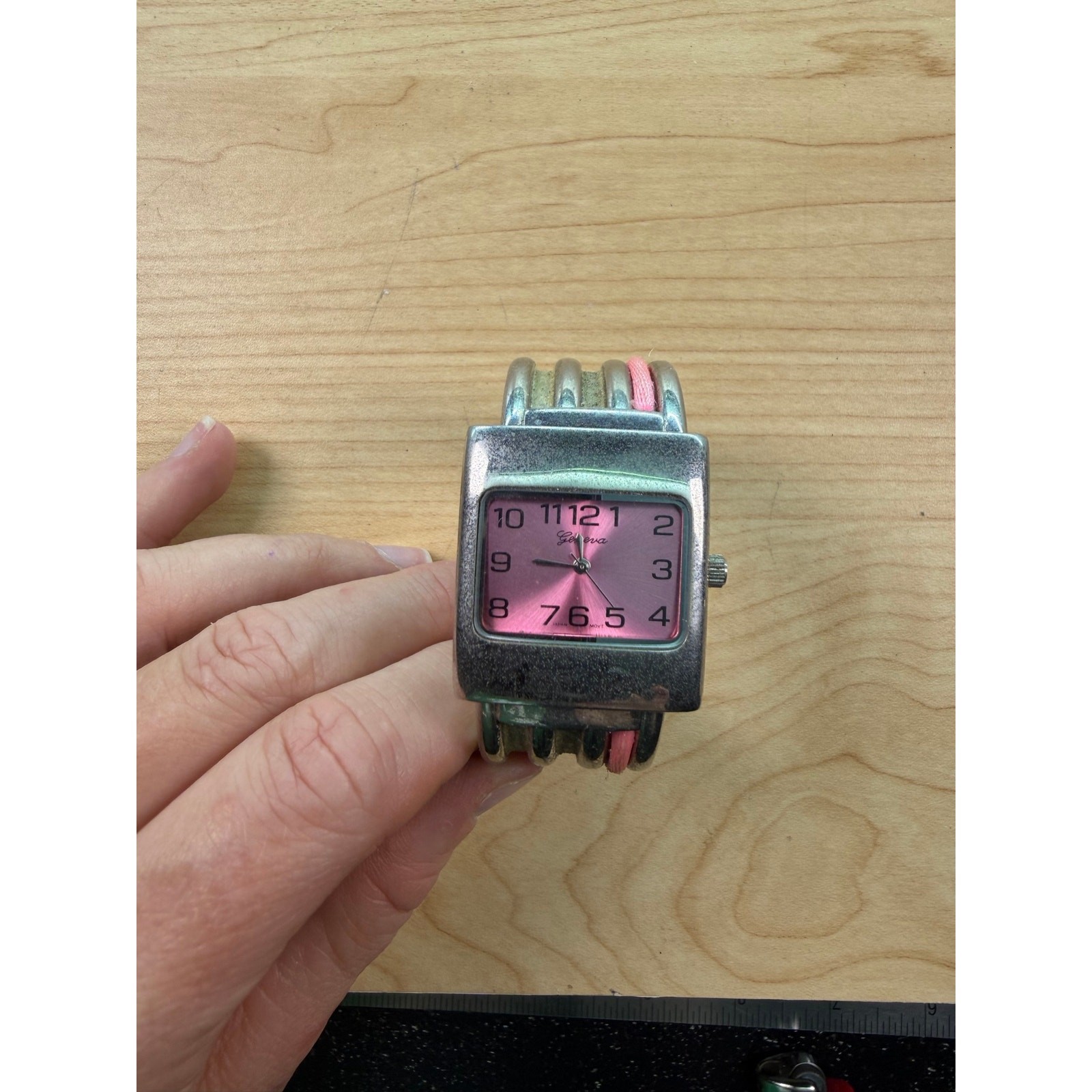 vintage women\'s Geneva silver-tone cuff watch with a pink dial. vintage women\'s Geneva silver-tone cuff watch with a pink dial.