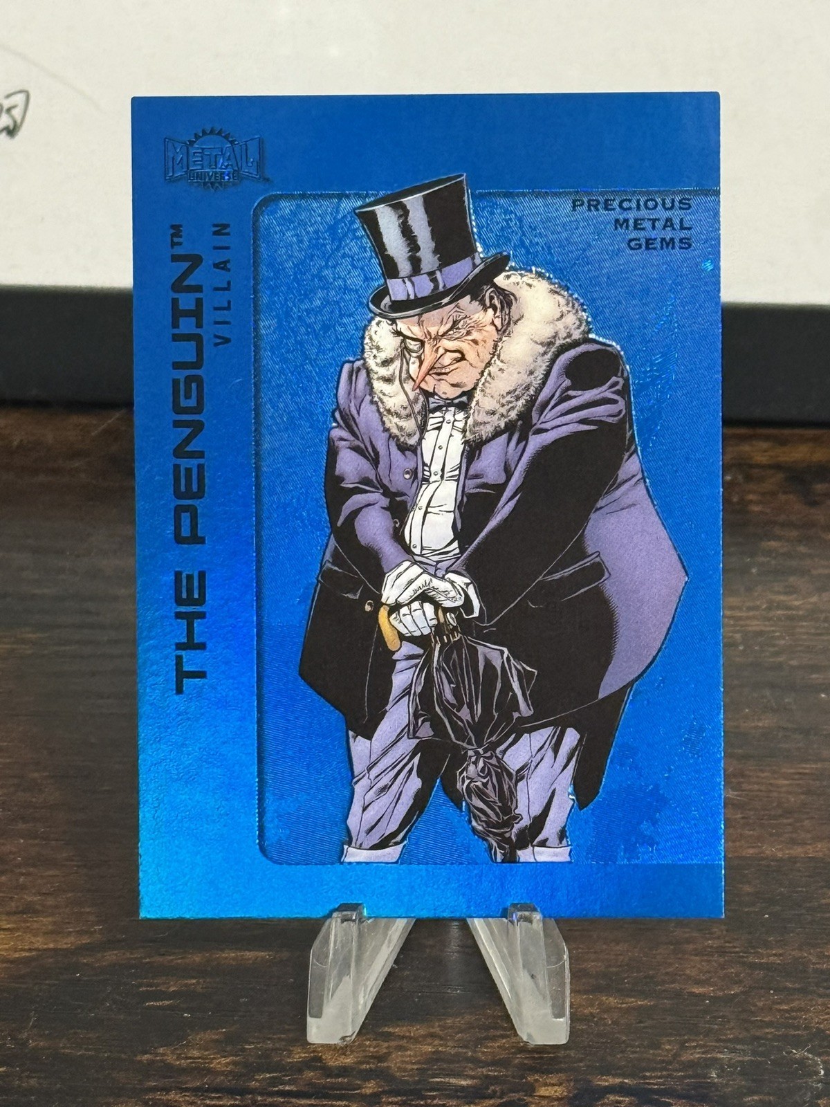 2025 Skybox Metal Universe Batman High Series PMG Blue 12/50 The Penguin #109