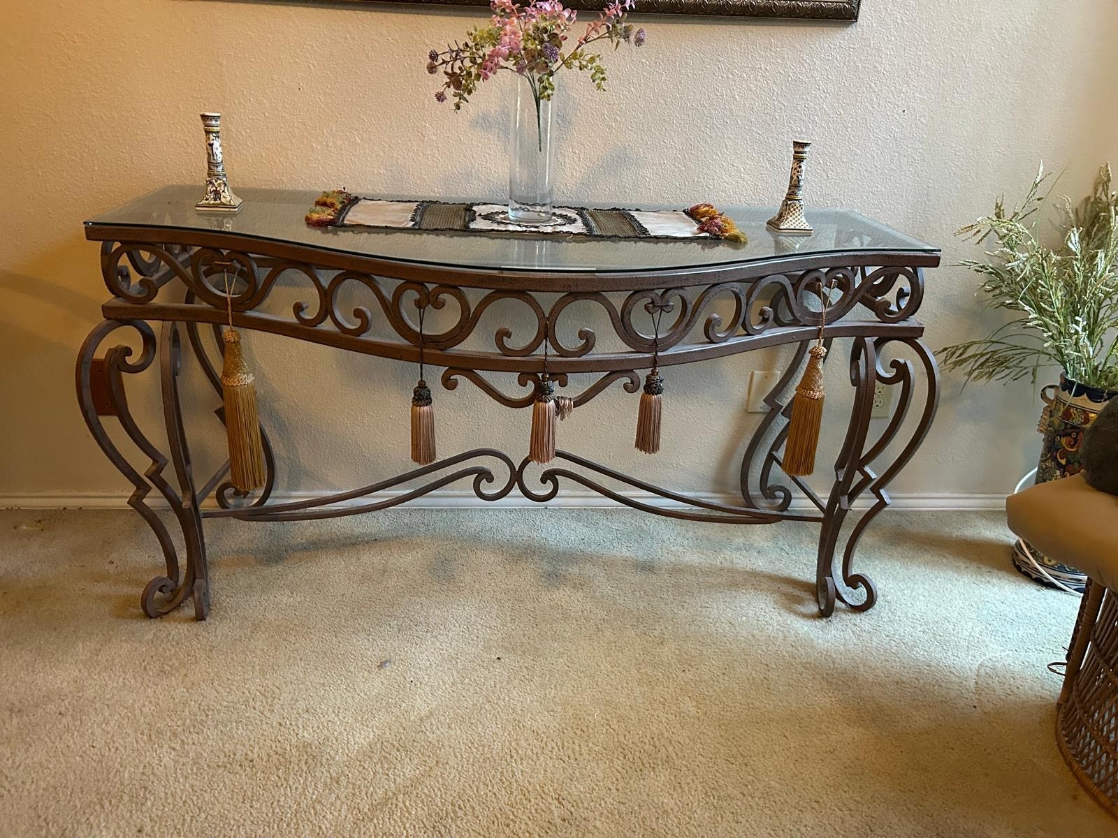 Handcrafted Iron console table with a beveled glass top. Wrought iron base.