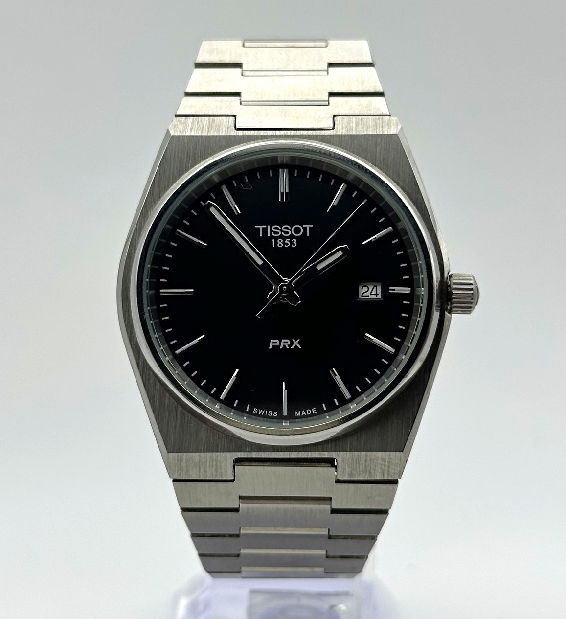 Tissot PRX Quartz 40mm with black dial and stainless steel integrated bracelet.