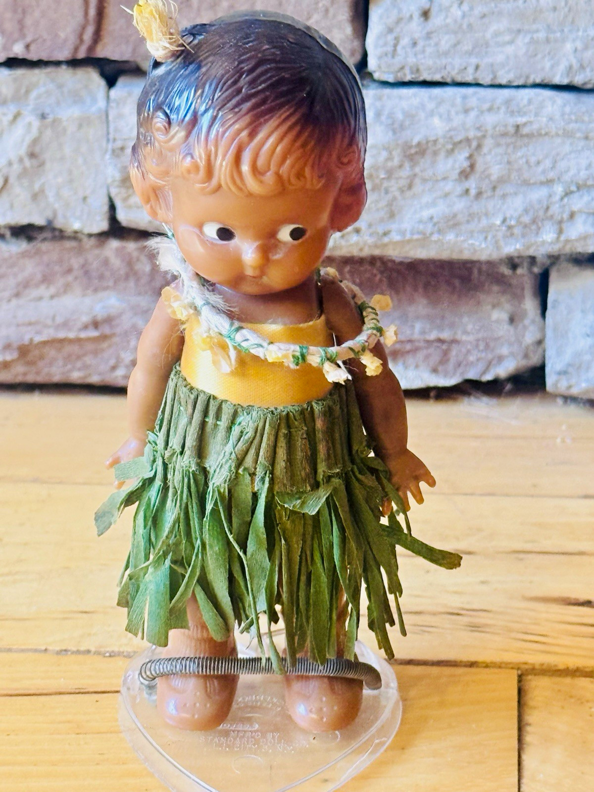 Knickerbocker hard plastic, vintage doll with stand and homemade hula outfit.