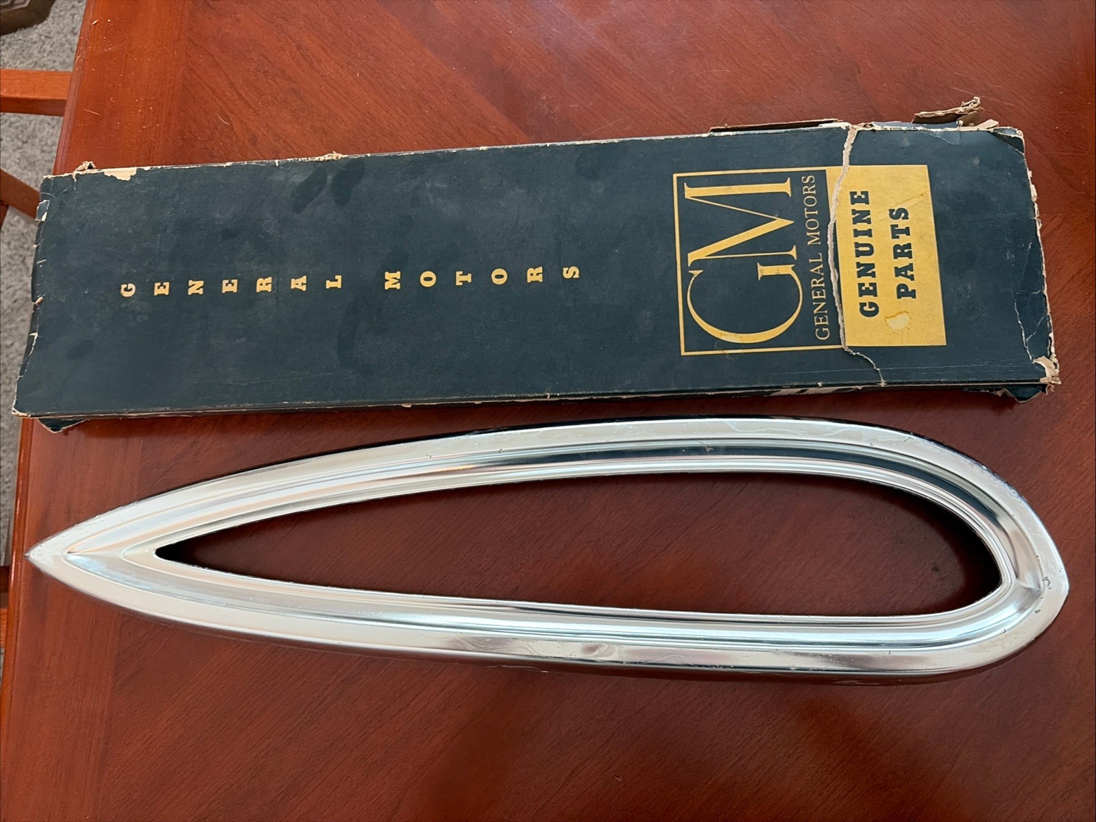 1959 Chevy tail lite bezel in GM box dented NOS Driver Side