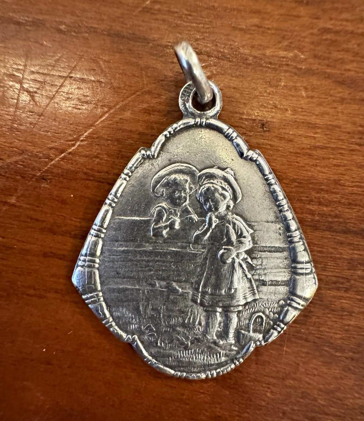 Antique Art Nouveau German Silver Repoussé Sweethearts on Fence Charm or Pendant Antique Art Nouveau German Silver Repoussé Sweethearts on Fence Charm or Pendant