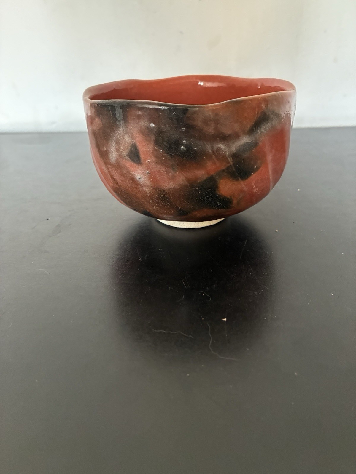 A FINE SHORAKU SASAKI OR KAWASAKI WARAKU RED GLAZED TEA BOWL