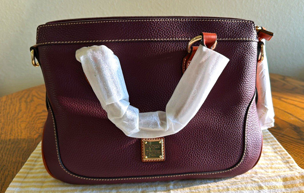Dooney & Bourke 100% Leather, leather tassels, leather long Strap. Reg Card.