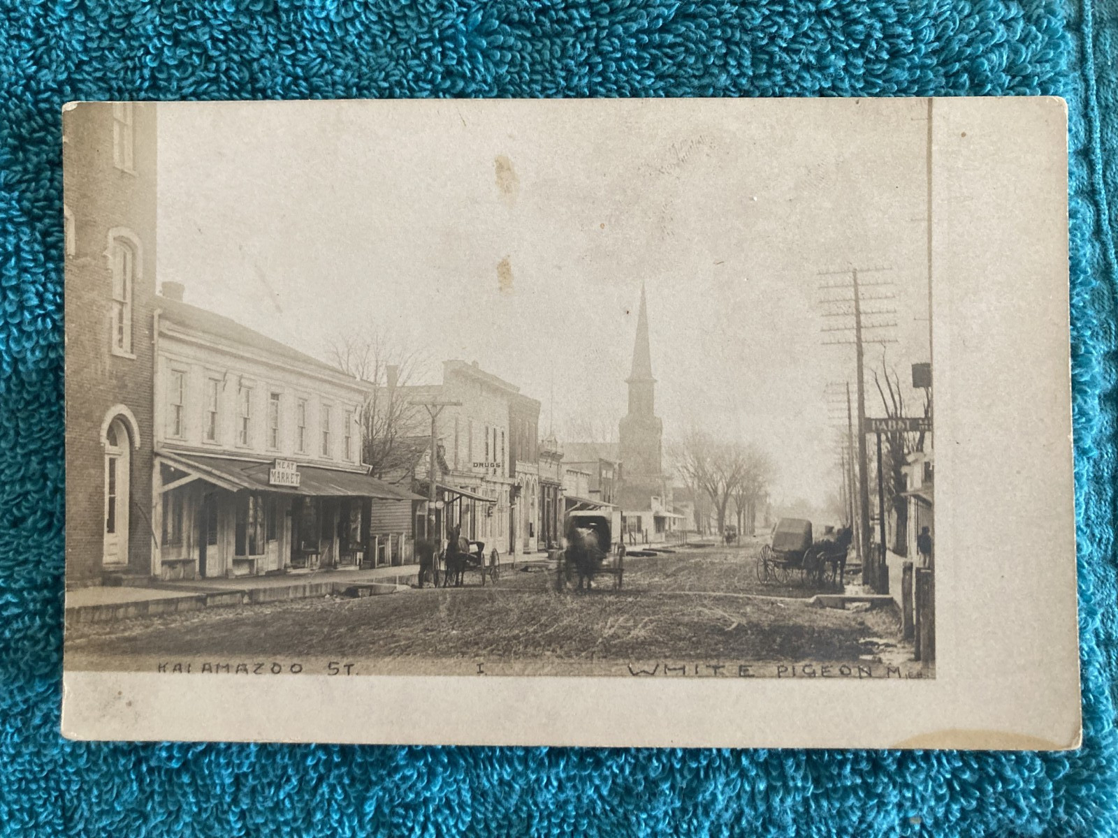 RPPC White Pigeon, Michigan Kalamazoo St. Town View JH Cave Early Photo c1905