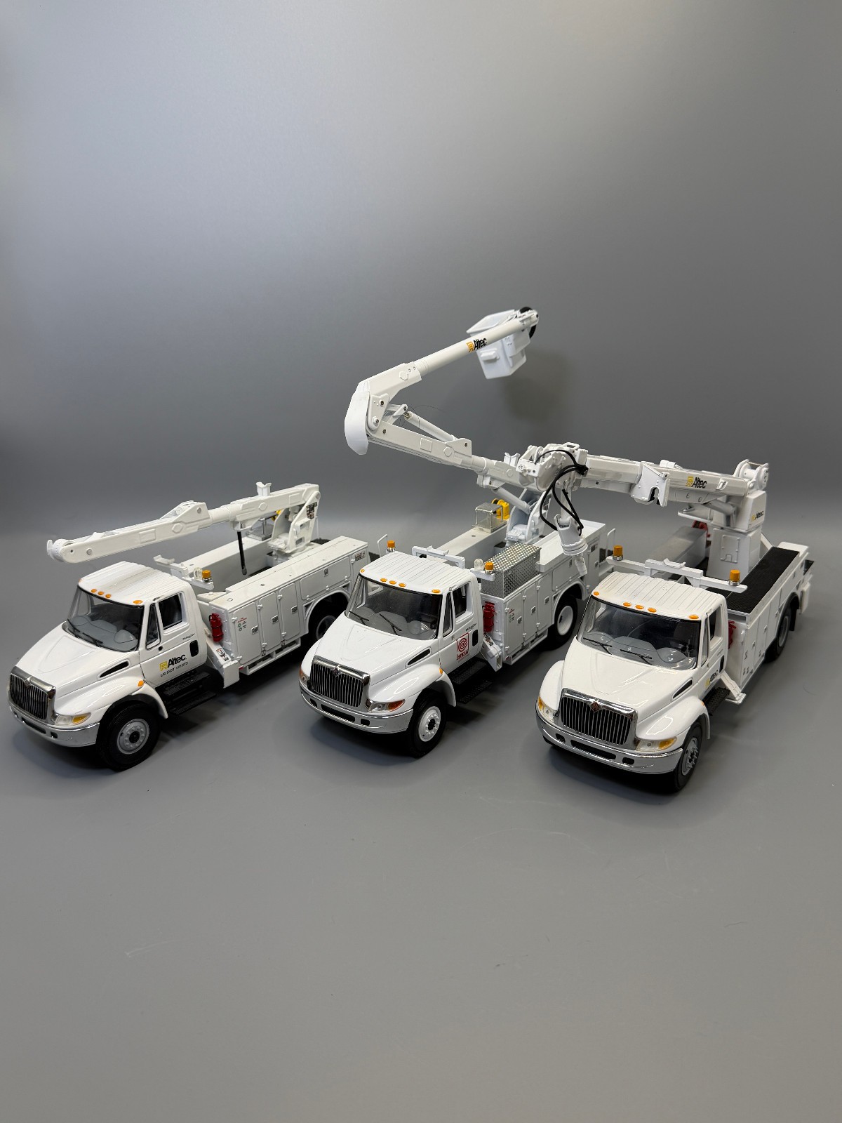 Lot of 3 First Gear Altec International DuraStar 1:34 Diecast Utility Trucks