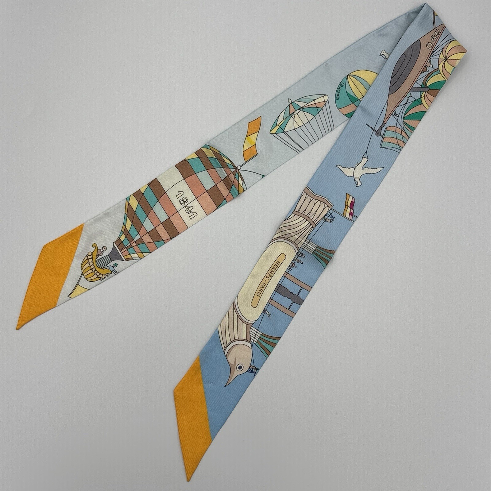 Hermès Twilly Les Folies du Ciel Silk Scarf Blue Sky Mustard Hot Air Balloon 