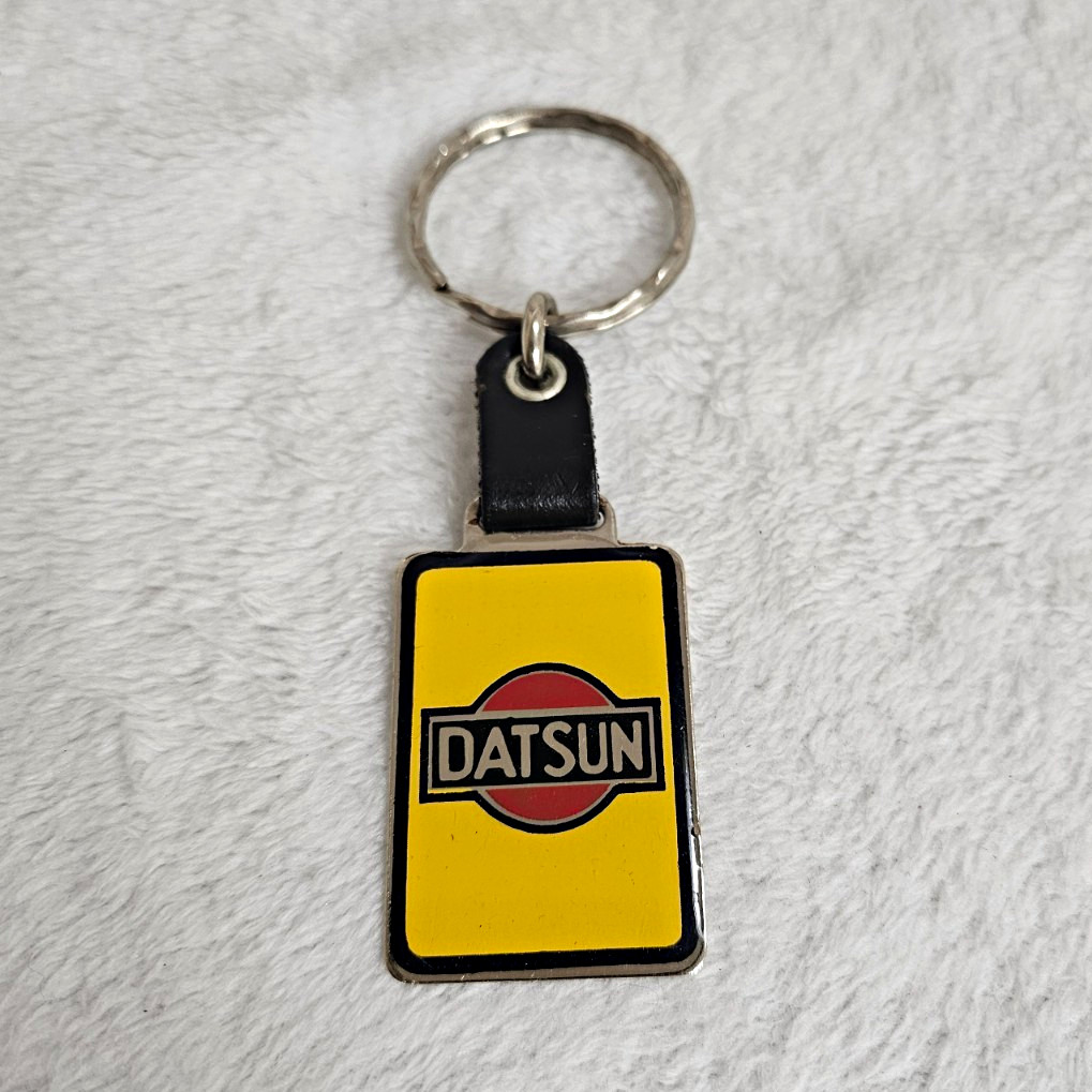 Vintage Datsun Keychain Leather Enamel Yellow Black Red Logo Fob NOS