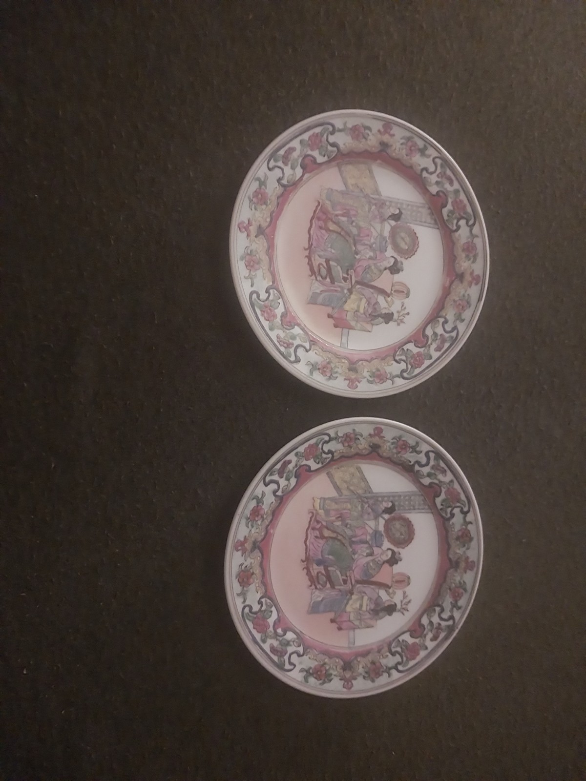 Chinese Famille Rose porcelain plates featuring a hand-painted figural scene. Chinese Famille Rose porcelain plates featuring a hand-painted figural scene.
