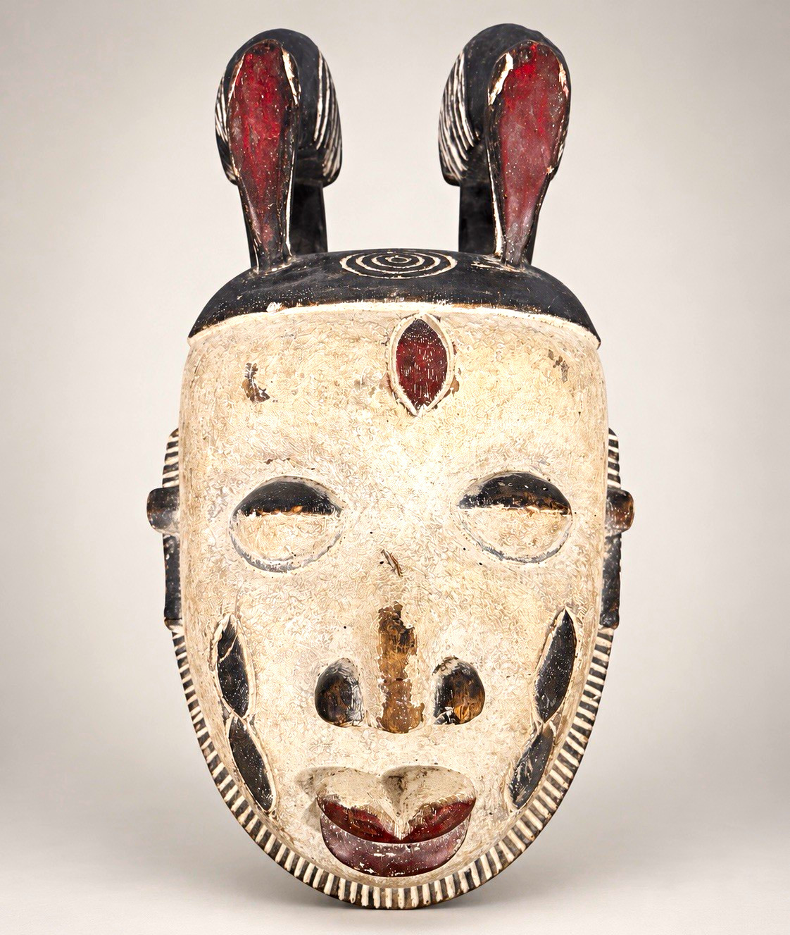 Hand-Carved African Mask, Painted Wood Face, Twin Crests with Raised Figures Hand-Carved African Mask, Painted Wood Face, Twin Crests with Raised Figures