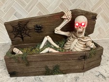Skeleton Rising out of Coffin Eyes Light Up Red Spooky Halloween Home Decor 15” picture