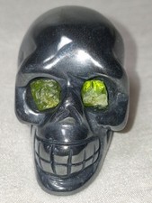 Hematite Skull with Peridot Eyes Hand Carved and Polished  picture
