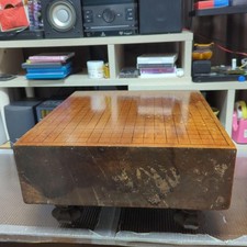 Vintage Go board with legs (featuring a *heso* resonance cavity) and Go stones. picture
