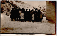 c1909 Large Group of Children Women on Snowy Hillside RPPC Postcard Winter Scene picture