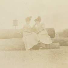 Vintage RPPC Two Women sitting on Logs in Dresses c. early 1900's Real Photo  picture
