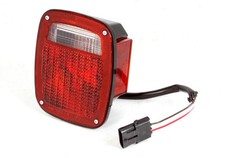 Omix-ADA Right Side Black HousingTail Light Assembly for 91-97 Jeep Wrangler picture