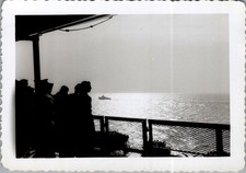 Silhouetted Figures on Ship Deck, Distant Boat, Mid-Century Ocean Voyage picture