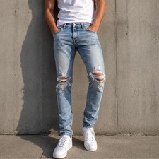 ASOS light wash distressed skinny jeans with heavy ripped knee detailing picture