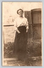 Vintage RPPC Young Woman Smiling Hands in Pockets Outdoors Early 1900s Postcard picture