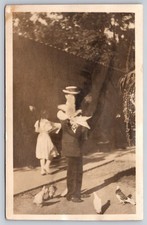 Scenic Candid RPPC of Man seemingly catches/releases pigeon captured in motion picture
