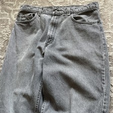 Vintage USA made Levi’s Men’s faded and distressed jeans with a loose fit picture