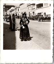 A COSTUMED WOMAN POSES BY SACOR GAS PUMP: VIANA DO CASTELO DISTRICT IN PORTUGAL picture