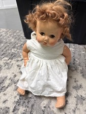 vintage mid-20th-century baby doll, resembling classic composition or hard-plast picture